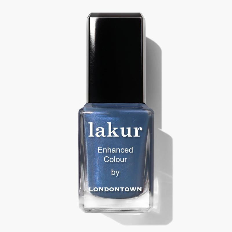 A bottle of LONDONTOWN’s Lakur Enhanced Colour nail polish in the Blue Diamond shade, featuring a sporty blue hue and a black cap, positioned against a white background.
