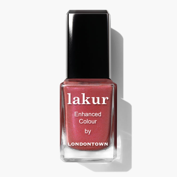 A bottle of LONDONTOWN Lakur nail polish in the shade Slopeside, a chrome dusty rose, with the text "Enhanced Colour by Londontown" on the bottle.