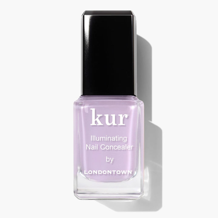 A bottle of LONDONTOWN Lavender Illuminating Nail Concealer, a light lavender polish with a perfecting formula, shown against a white background.