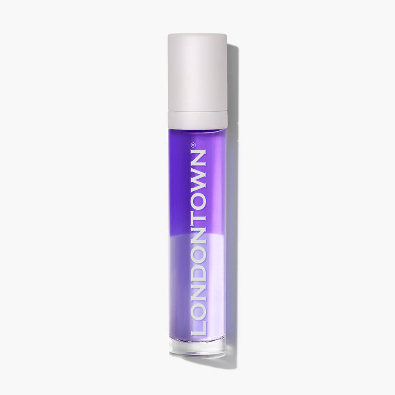 A bottle of LONDONTOWN nail polish with purple liquid and a white cap against a white background sits beside the Nighttime Cuticle Quench - Lavender, perfect for overnight cuticle repair.