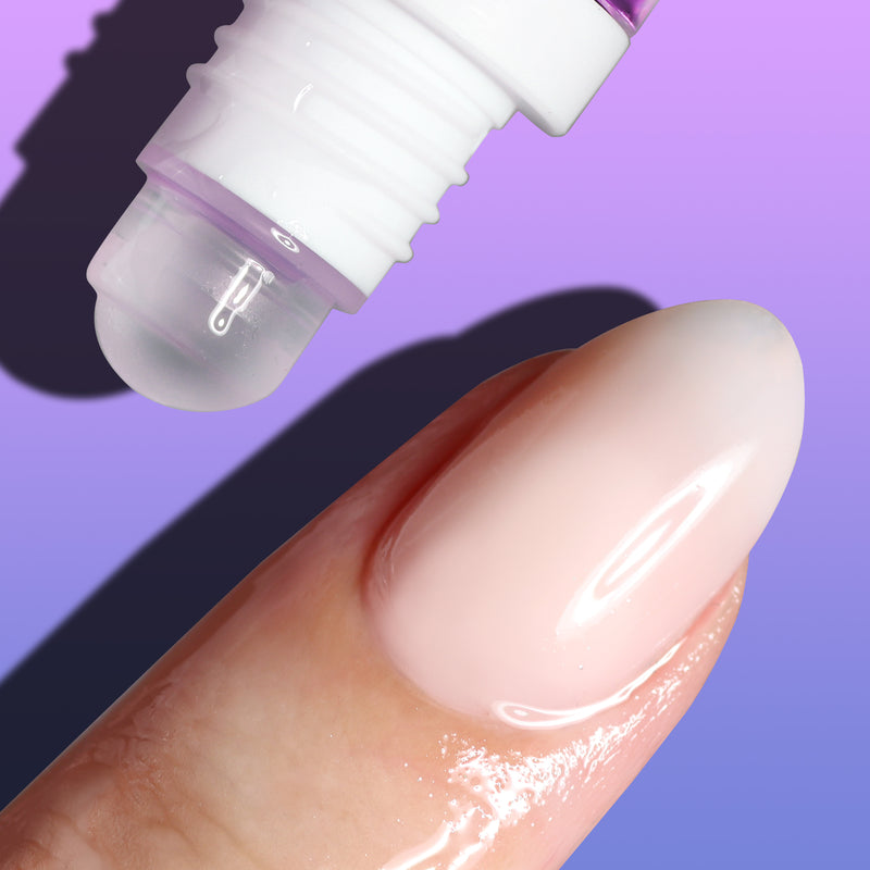 A close-up shot of the Nighttime Cuticle Quench - Lavender roll-on applicator by LONDONTOWN dispensing clear liquid gel for soothing cuticle treatment onto a finger, set against a purple gradient background.
