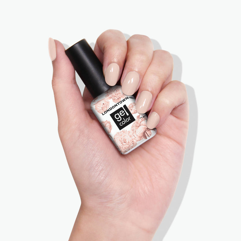 A hand holds a LONDONTOWN gel color nail polish bottle labeled "Linen," featuring soft floral designs. The nails are painted in the same breezy beige tone, exuding natural elegance.