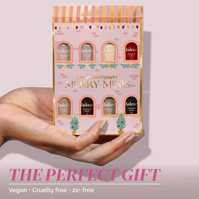 A hand holds the LONDONTOWN Merry Minis Set, featuring six festive vegan, cruelty-free polishes—21+ free and perfect for holiday gifting.