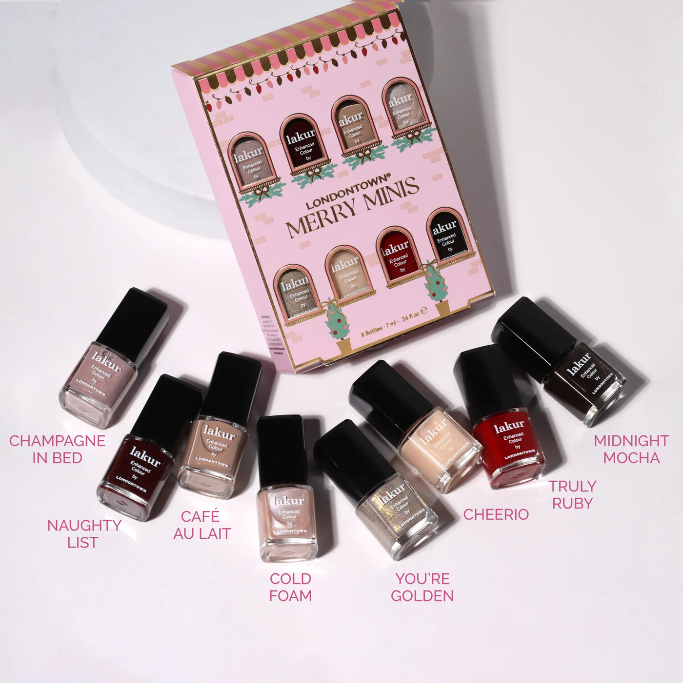LONDONTOWN's Merry Minis Set features seven festive mini nail polishes, perfect for holiday manis, displayed in front of a cheerful holiday-themed "Merry Minis Set" box.