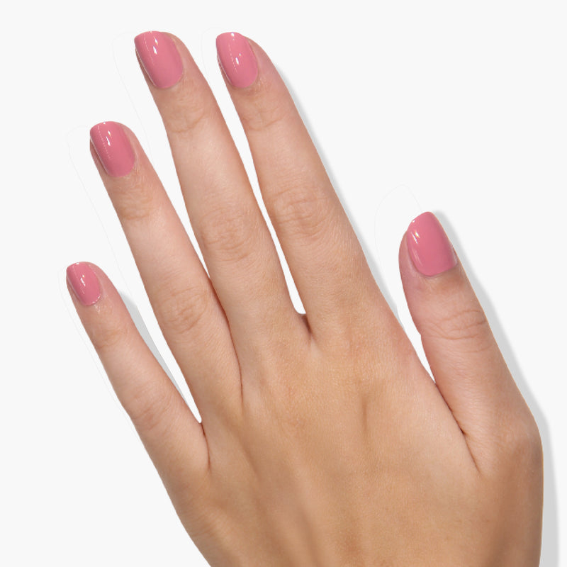A hand with manicured nails painted in LONDONTOWN's Mojave Mauve is shown against a white background, exuding a ladylike, sophisticated charm.