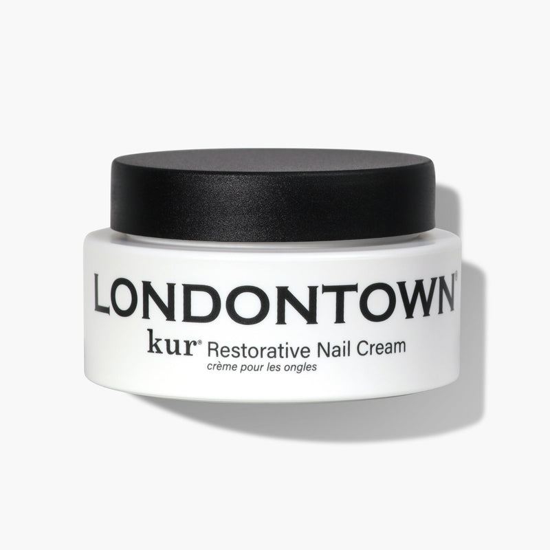 A white container with a black lid, bearing the label "LONDONTOWN Restorative Nail Cream" in black text, promises a transformative moisturizer for dry nails.