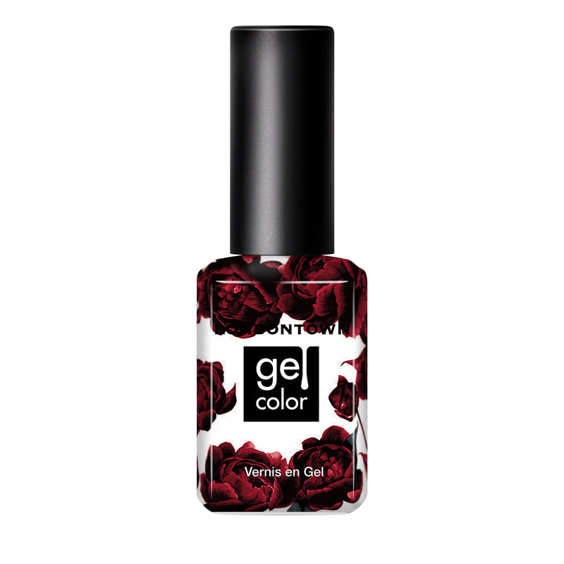 A bottle of LONDONTOWN's Naughty List gel nail polish featuring a black cap and label adorned with dark red roses, evoking the rich hue of a full-bodied merlot.