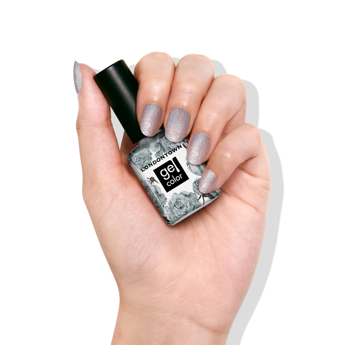 A hand with platinum silver glitter gel polish holds a "LONDONTOWN Nice & Icy" bottle featuring a floral label, highlighting its chic, holographic shimmer.