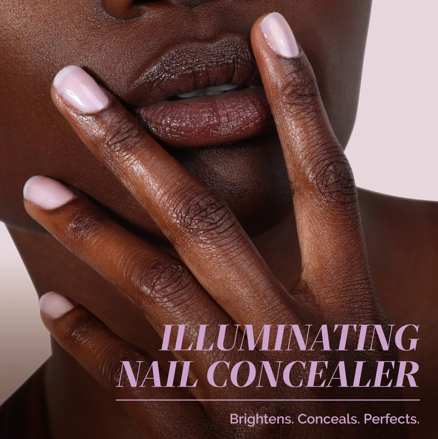 Close-up of a person with medium-dark skin tone touching their face, showing light pink polished nails. Text reads: "One-Step Hero Minis by LONDONTOWN. Brightens, conceals, and perfects nails—care and color in one step.