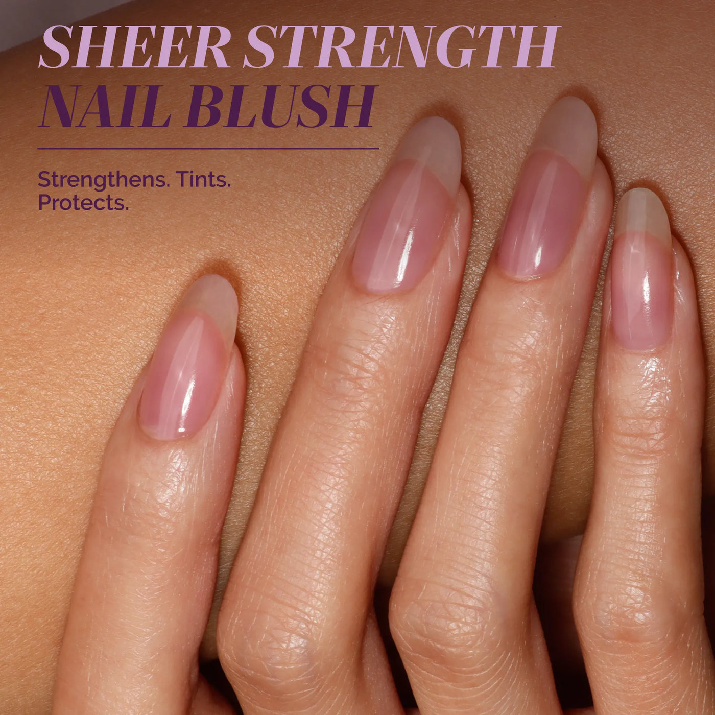 A hand with long, natural nails painted in a glossy, sheer pink. Text: "One-Step Hero Minis by LONDONTOWN—Strengthens, tints, protects. The perfect color and care solution for your nails in one easy step.