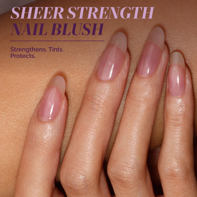 A hand with long, natural nails painted in a glossy, sheer pink. Text: "One-Step Hero Minis by LONDONTOWN—Strengthens, tints, protects. The perfect color and care solution for your nails in one easy step.