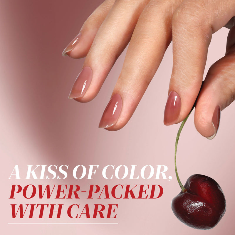 A hand with glossy, nude-colored manicured nails holds a cherry by its stem, with the text: "A Kiss of Color, Power-Packed Care. Featuring LONDONTOWN Perfecting Nail Veil #10.