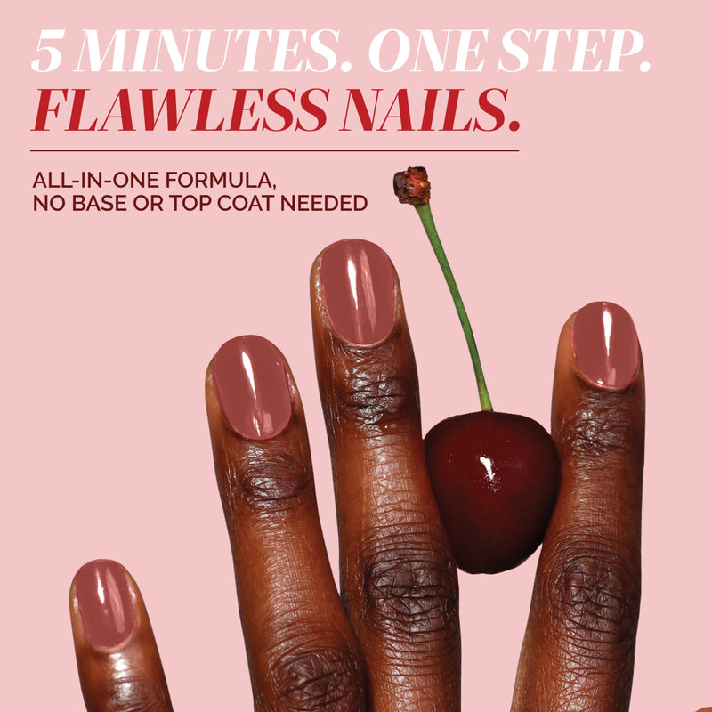 A hand with polished nails holds a cherry against a pink background. LONDONTOWN Perfecting Nail Veil #10 delivers care and vibrant shine in one step—no base or top coat needed, just a hint of color with every swipe.