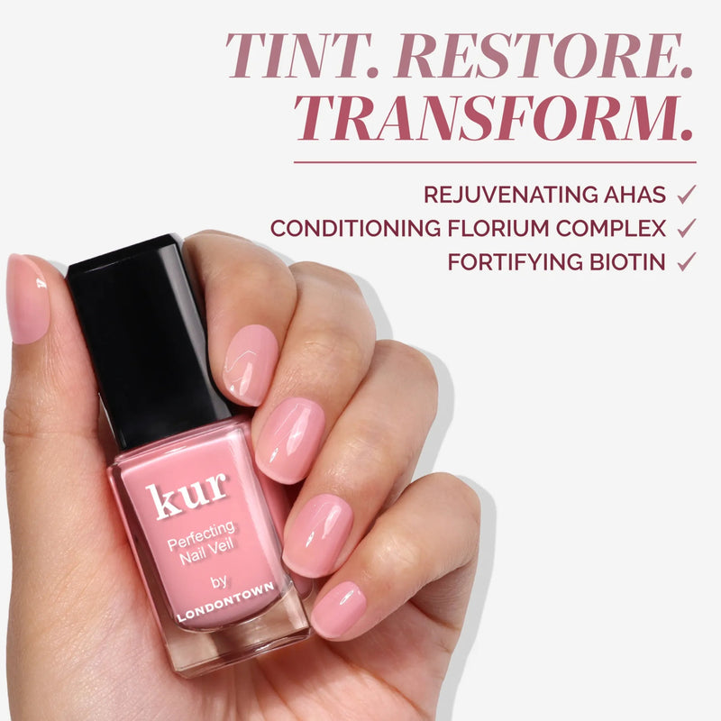 Hand holding a bottle of LONDONTOWN Perfecting Nail Veil #7; enriched with AHAs, Florium Complex, and biotin for healthy nails—like a tinted lip balm for your nails, offering moisturizing and nourishing care.
