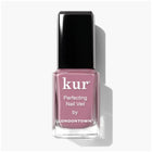 A bottle of LONDONTOWN Perfecting Nail Veil #11 with a black cap sits on a white background—an ideal match for your favorite tinted lip balm, creating a polished and coordinated look.