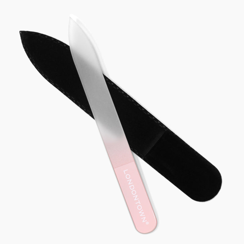 The Glass Nail File - Petal, branded "LONDONTOWN" and featuring a pink handle, is partially inserted into its black protective case, ensuring effortless and damage-free nail filing.
