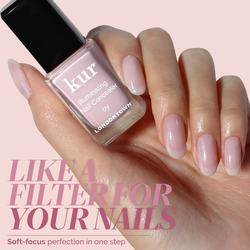 A manicured hand holds a bottle of LONDONTOWN Pink Illuminating Nail Concealer. Text reads, “Like a filter for your nails—get soft-focus perfection and a milky pink illuminated finish in one step.”.