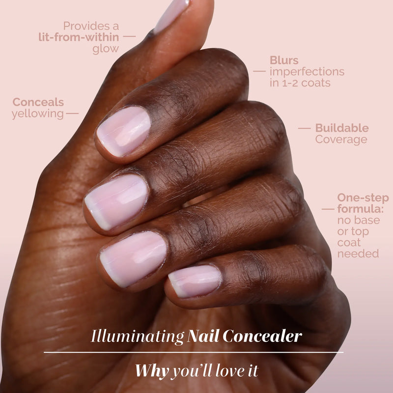 A medium brown hand shows nails painted with LONDONTOWN Pink Illuminating Nail Concealer, a one-step formula offering sheer milky pink color, buildable coverage, and a brightening effect.