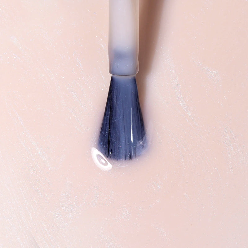 A close-up of LONDONTOWN’s Pink Illuminating Nail Concealer brush applying light pink polish to a nail, creating an elegant, flawless milky pink finish.