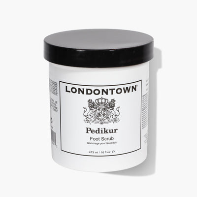A white and black jar labeled "LONDONTOWN Foot Scrub (Pro Size)," with a capacity of 473 ml (16 oz), promises an invigorating treat for tired feet.