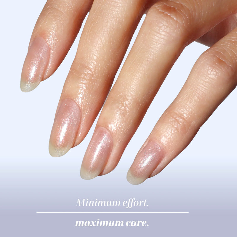 A hand with long, natural, well-manicured nails is shown against a light background, featuring an ethereal nail look achieved with LONDONTOWN Quartz Illuminating Nail Concealer and the text "Minimum effort, maximum care." at the bottom.