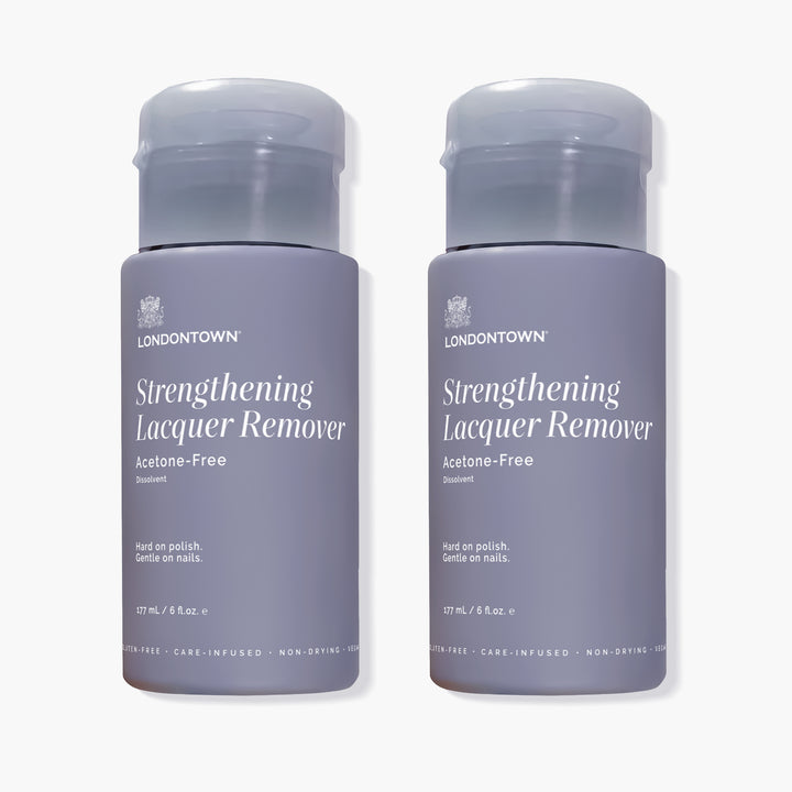 Two bottles of LONDONTOWN Strengthening Remover Duo, which are acetone-free strengthening nail polish removers with grey caps.