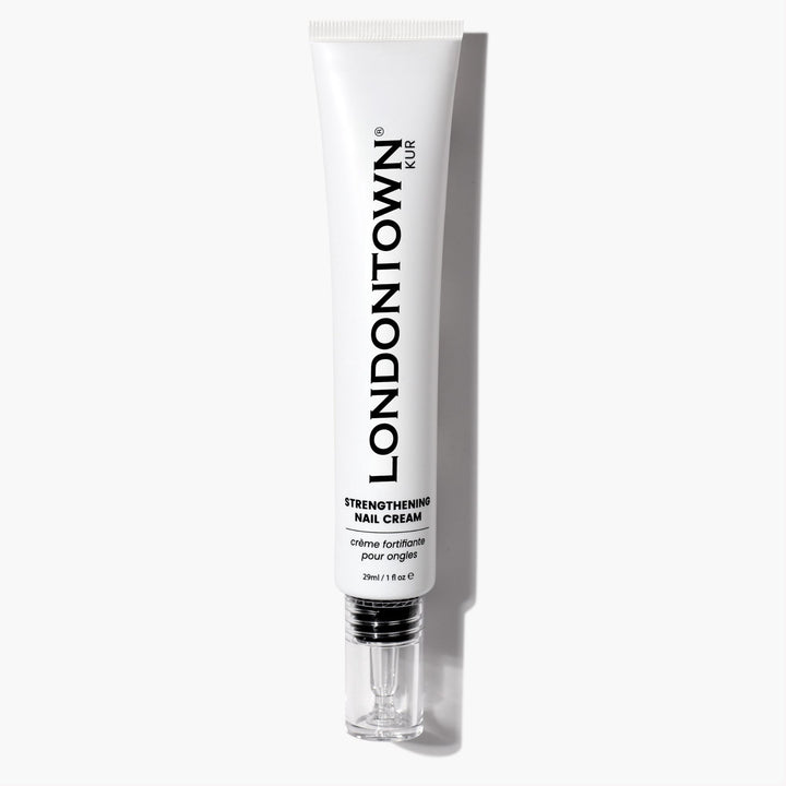 A 28ml white tube of LONDONTOWN Strengthening Nail Cream with a silver cap is pictured on a white background. This nourishing formula helps fortify and condition nails, promoting strength and healthy growth with regular use.