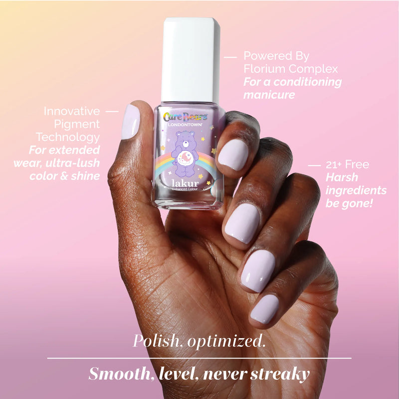 A hand with soothing light purple, lavender-inspired nails holds a bottle of LONDONTOWN Sweet Dreams polish; text highlights its conditioning formula and that it’s made with 21+ free ingredients.