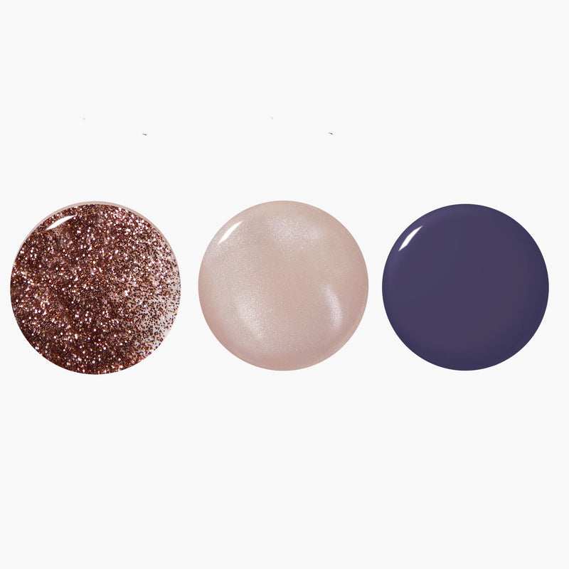 Three nail polish swatches from LONDONTOWN’s Moonlit Botanica Mini lakur trio—rose gold glitter, pearlescent beige, and solid dark purple—each displayed as round samples on a white background.