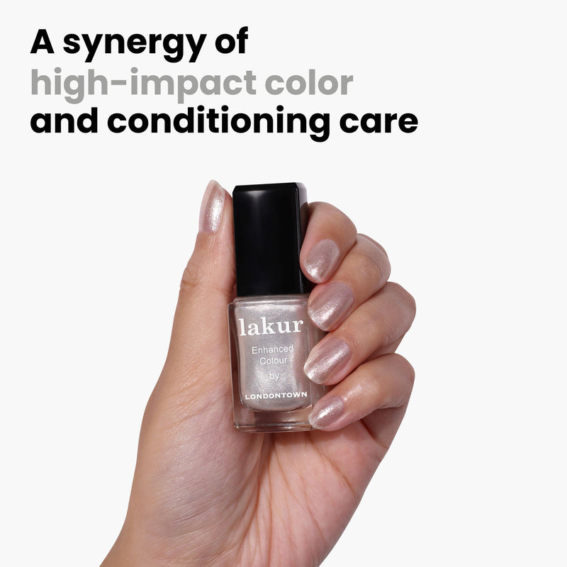 A hand holds a bottle of LONDONTOWN's Lakur "Coconut Crush," a shimmery pink shade with ultrafine glitter. Text reads, "A synergy of high-impact color and conditioning care.