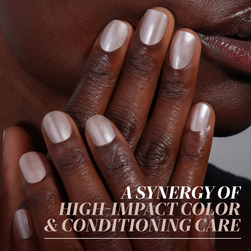 Close-up of medium to dark skin showing neatly manicured nails painted with LONDONTOWN Cold Foam, a light, shimmery polish; text reads "A synergy of high-impact color & conditioning care.