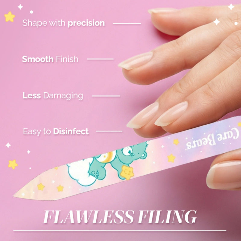 A hand shows precise, gentle nail filing with the LONDONTOWN Glass Nail File - Wish Bear, featuring a pastel Care Bears design on pink. Achieve smooth, damage-free nails that are easy to disinfect for effortless care.