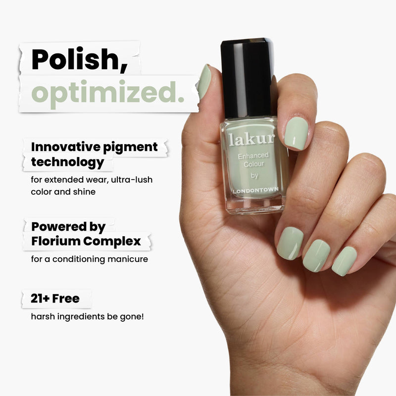 A hand holds a bottle of Lichen, a light green nail polish by LONDONTOWN, infused with white sage. It features innovative pigment technology, the Florium Complex, and is 21+ free of harsh ingredients.