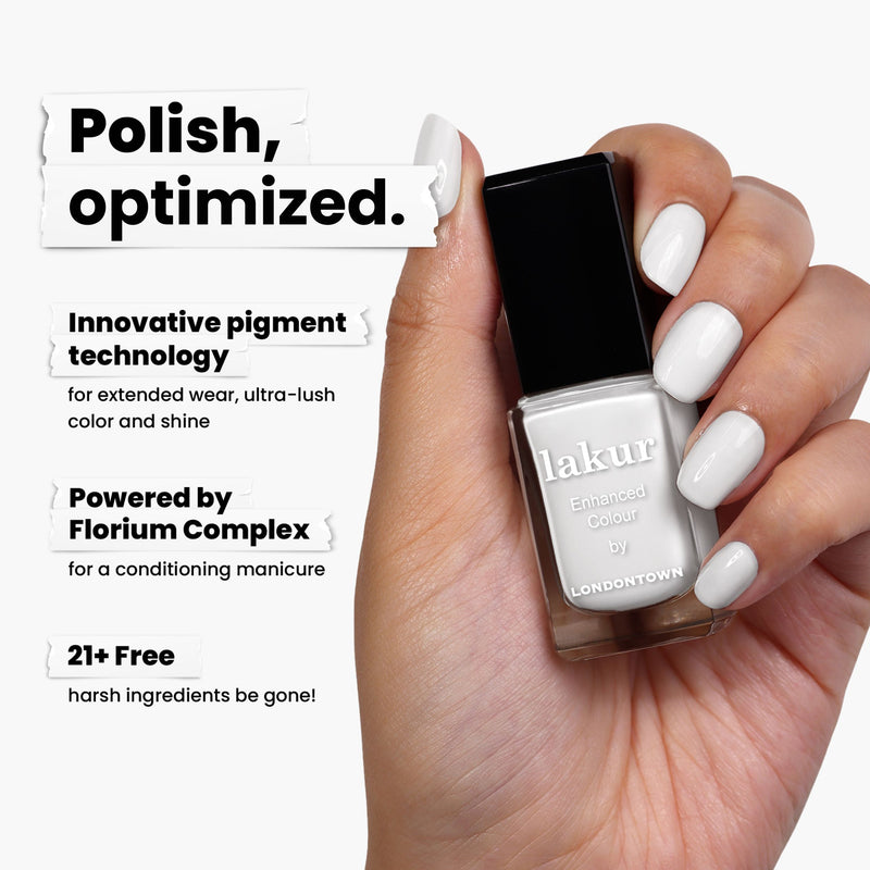 A hand holds a "London Fog" bottle, a crisp white nail polish by LONDONTOWN labeled as "lakur." Its text highlights innovative pigment powered by Florium Complex and being 21+ free of harsh ingredients.