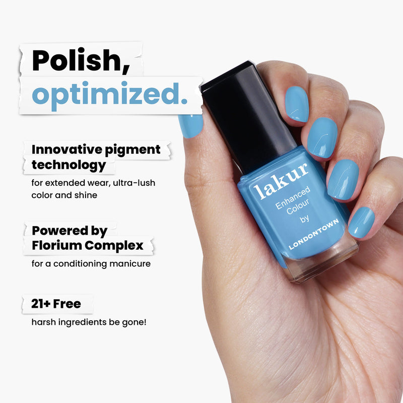 A hand proudly holds a bottle of LONDONTOWN's "lakur Enhanced Colour" nail polish called Hot Spring, reminiscent of Pacific pool blues. It features innovative pigment technology, Florium Complex, and is free from 21+ harsh ingredients.