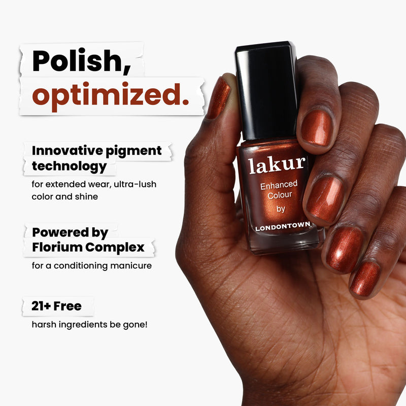 A hand gracefully displays LONDONTOWN's Posh Forever nail polish in a striking metallic brown-copper shade akin to warm cinnamon, highlighting its unique pigment technology, Florium Complex, and the exclusion of 21+ harsh ingredients for a gentle application.