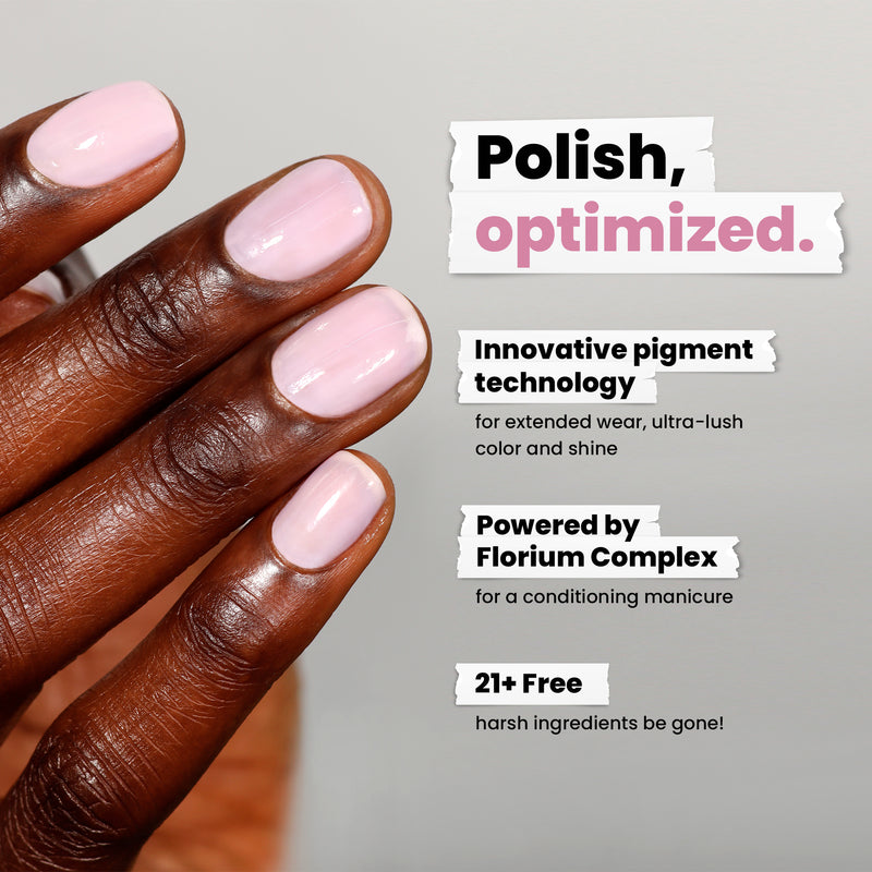 A hand showcases sheer, petal pink polished nails using LONDONTOWN's Magnolia Haze. It features innovative pigment technology, Florium Complex for conditioning, and removes 21+ harsh ingredients, making it versatile for any style or occasion.