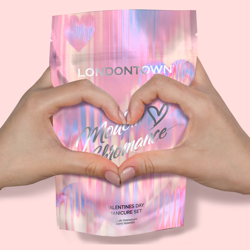 Two hands form a heart in front of a pink, iridescent LONDONTOWN box labeled "Modern Chromance Valentine’s Day Set"—the ultimate love story for your nails.