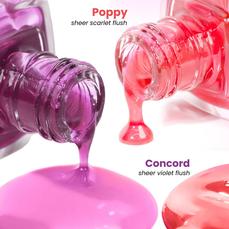 Two bottles of nail polish spill onto a surface. One is "Poppy," a sheer scarlet, and the other is LONDONTOWN's "Sheer Strength Nail Blush - Concord," a sheer violet glow booster. This 2-in-1 duo offers vibrant color plus nail hardening benefits for lasting shine and strength.