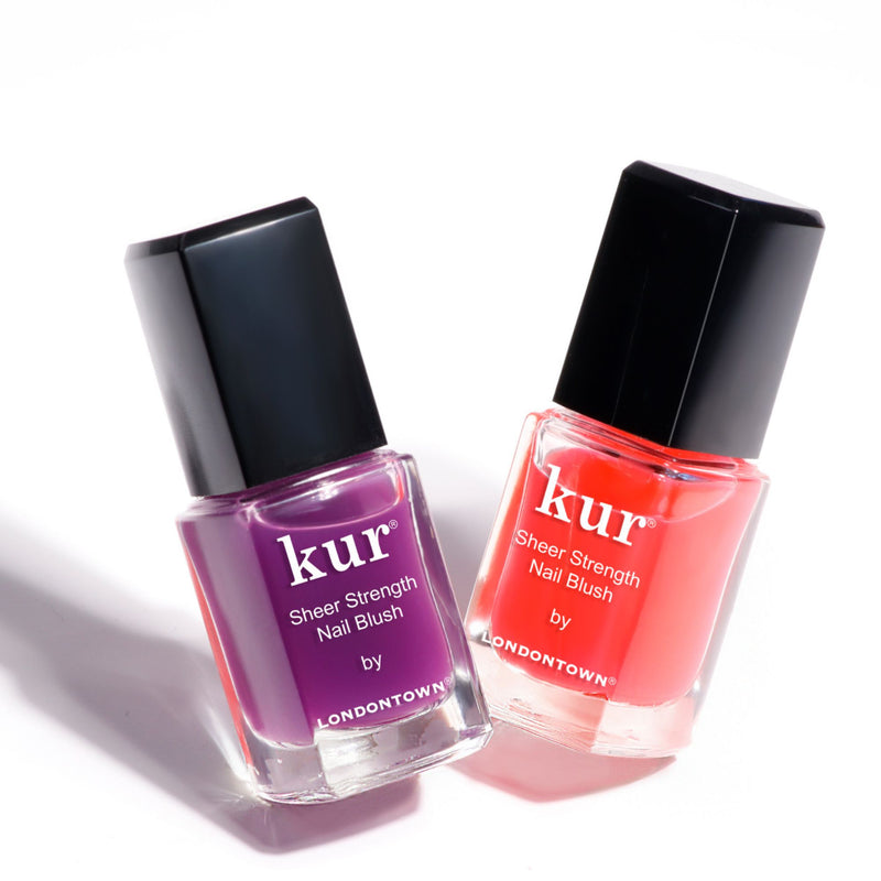 Two bottles of "Sheer Strength Nail Blush - Concord (Professional)" by LONDONTOWN. This 2-in-1 formula acts as a nail hardener and includes purple and orange-red colors, each with a black cap.