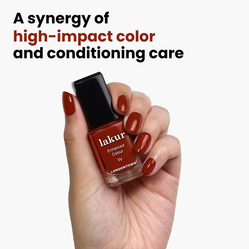 A hand holds a bottle of LONDONTOWN's "You Autumn Know," a rich, reddened umber hue, with the text “A synergy of high-impact color and conditioning care” in the background.