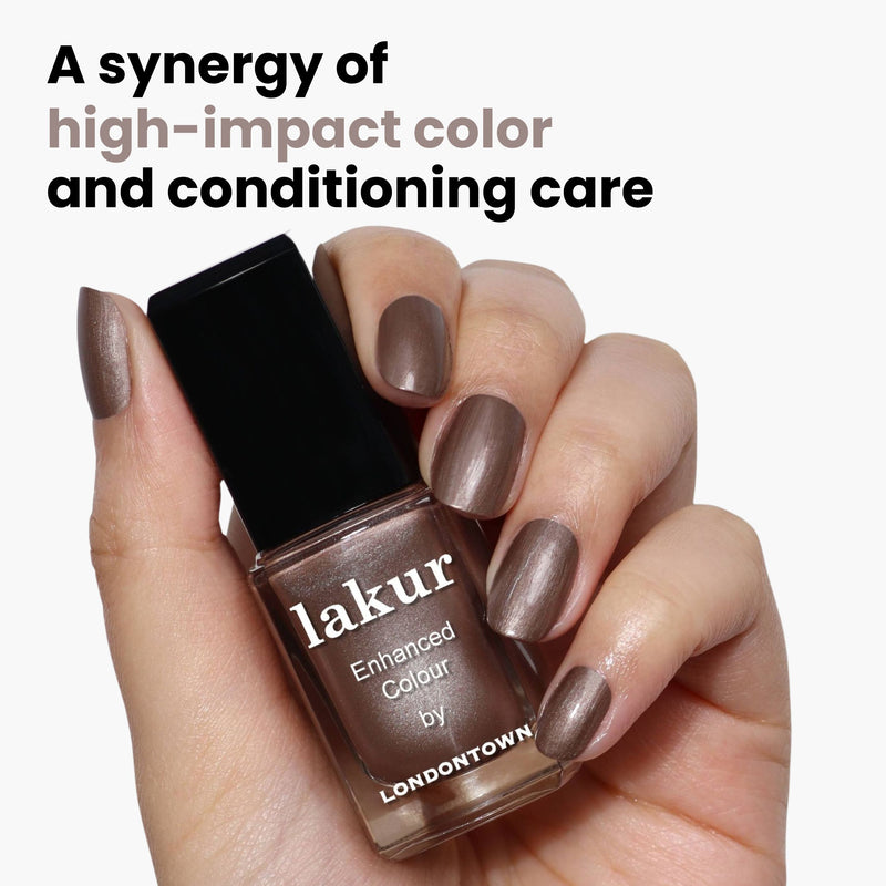 A hand holds a bottle of LONDONTOWN's Lakur nail polish in the Nightcap shade, offering a mix of striking color and nourishing care.