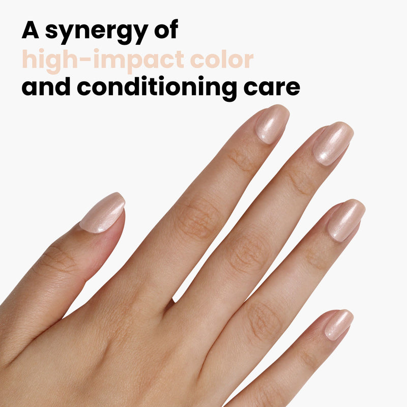 A hand with metallic peach nails polished in LONDONTOWN's "Pearl" is set against a plain white background, showcasing the synergy of vibrant color and nourishing care.