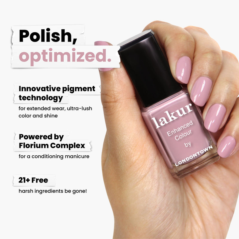 A hand holds a bottle of pink nail polish labeled "Berry Nude by LONDONTOWN," featuring innovative pigment technology, Florium Complex, and a "21+ Free" formulation. Experience the delectable blend as dreamy as blueberry whipped cream when applied.