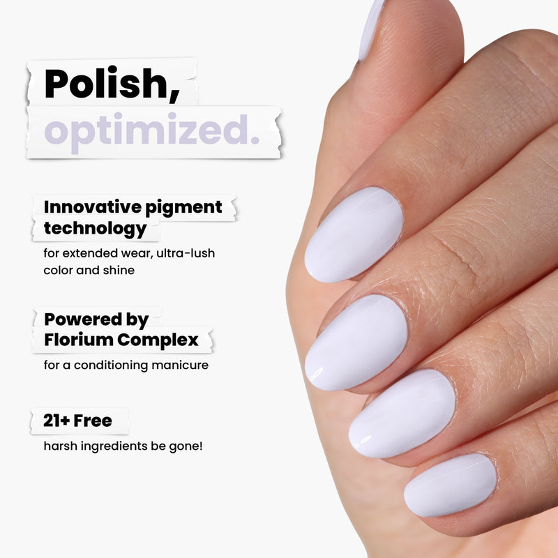 A hand with short, rounded nails is painted chic ice blue using LONDONTOWN's Frostbitten polish, featuring innovative pigment technology, Florioum Complex, and is free from over 21 harsh ingredients.