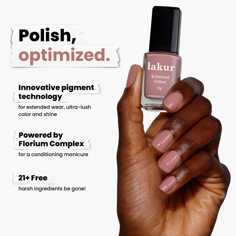 A hand holds the LONDONTOWN Crowning Crumpet (Professional) pink nail polish, featuring innovative pigment technology and Florium Complex. This 21+ free, vegan, cruelty-free polish offers uncompromising beauty.