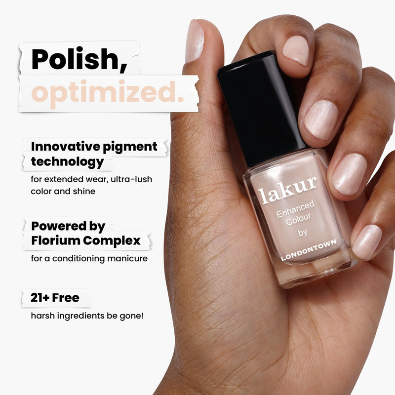 A hand displays LONDONTOWN's Pearl nail polish, highlighting its shimmering finish and innovative pigment technology. Enhanced with Florium Complex and free of 21+ harsh ingredients, it offers a safe, elegant look.