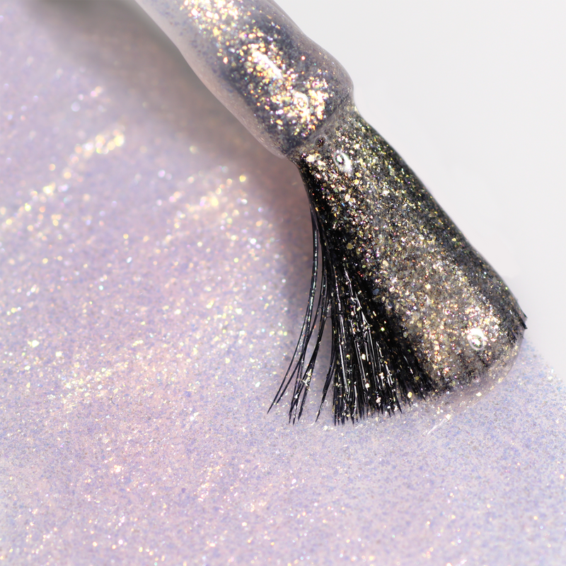 Close-up of a brush applying LONDONTOWN’s Shimmering Nail Highlighter - Sunkissed, delivering a smooth, luminous layer of iridescent shimmer.