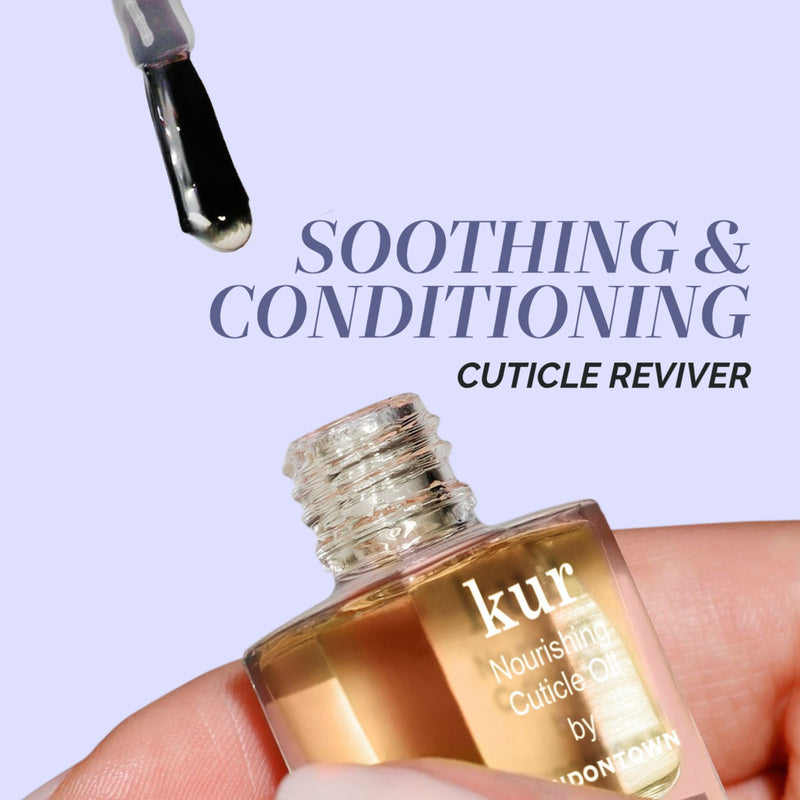 A hand holds the LONDONTOWN Jet Set Travel Nail Kit with a brush applicator. Perfect for on-the-go manis, this soothing kit keeps your nails conditioned and healthy wherever life takes you.