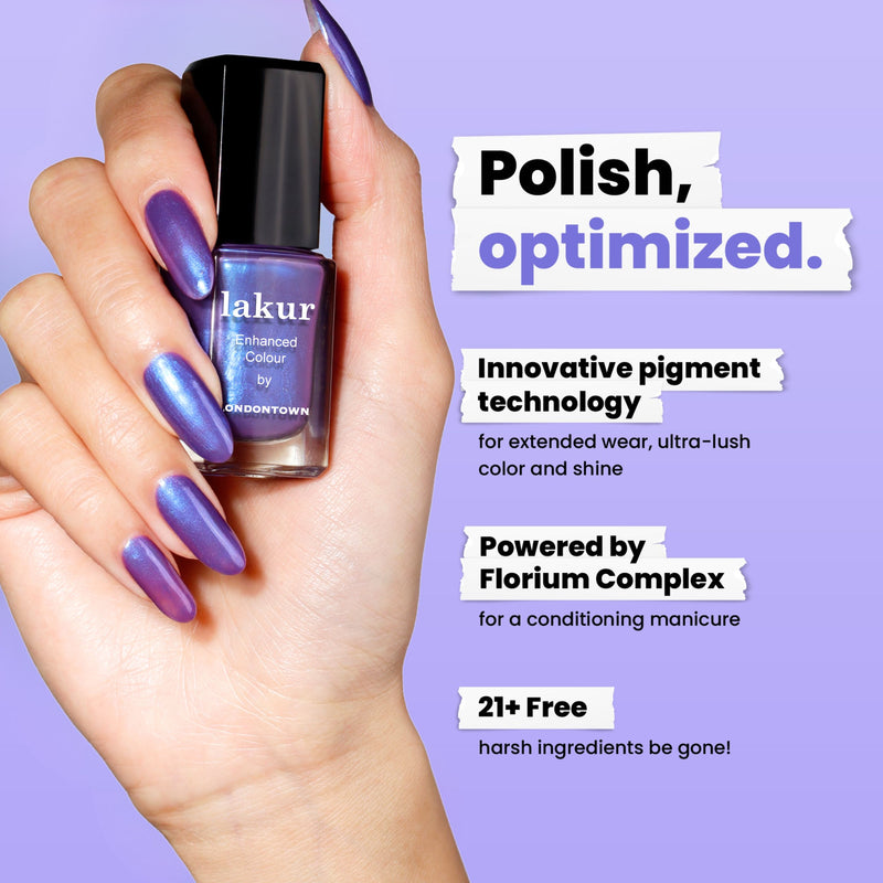 A hand with purple iridescent nails featuring a subtle blue shimmer holds a LONDONTOWN Wildberry Freeze bottle; text highlights its innovative pigments, conditioning complex, and its 21+ free clean formula.
